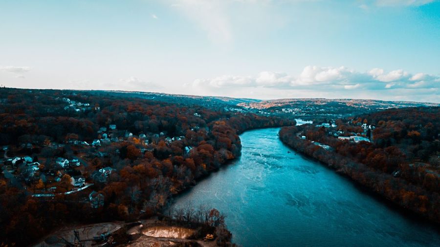 Aerial view of river and cityscape against sky