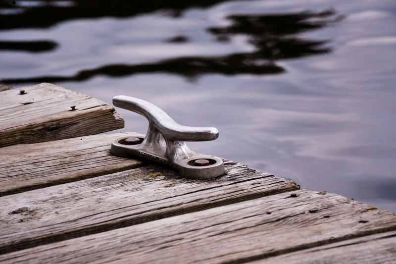 Boat cleat on the edge of rustic dock. crane lake, minnesota.