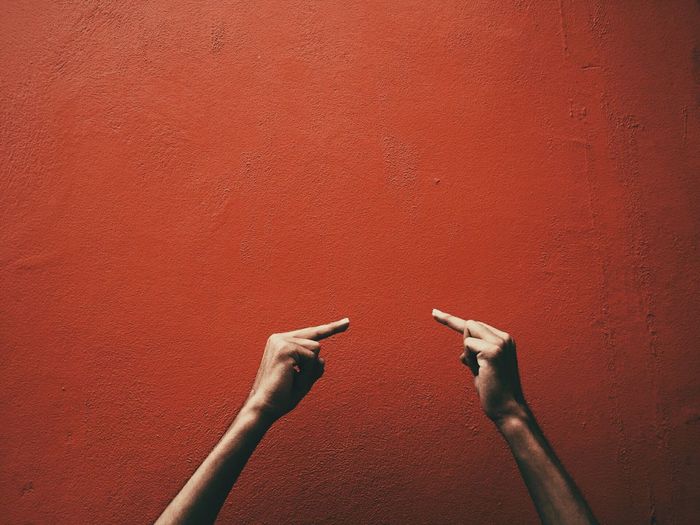 Obscene gesture against wall
