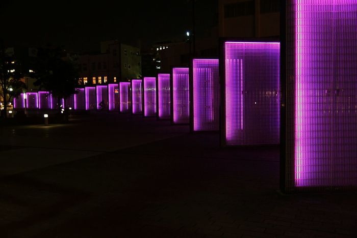 Illuminated purple panels at night
