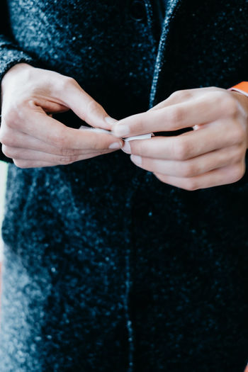 Close-up of person hands rolling paper