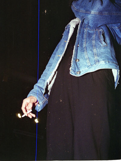 Man holding a cigarette in the dark
