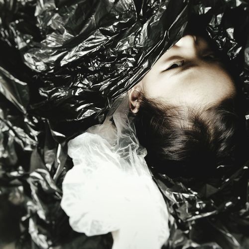 High angle view of girl in black plastic