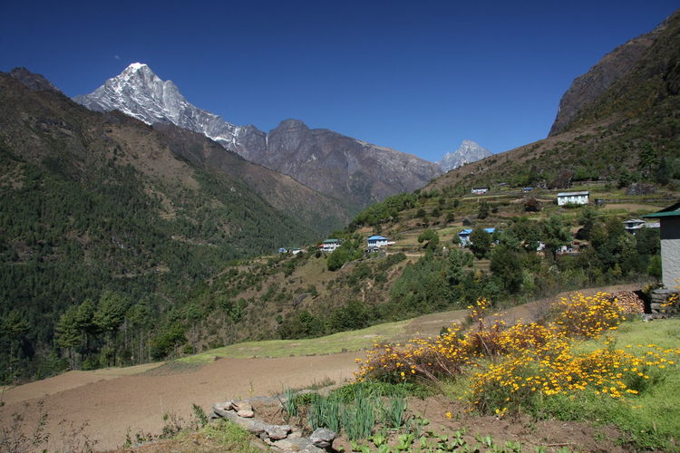 Scenic view of road by mountains against clear sky in the khumbu valley