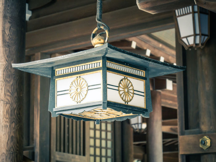 Close-up of lantern hanging on ceiling of building
