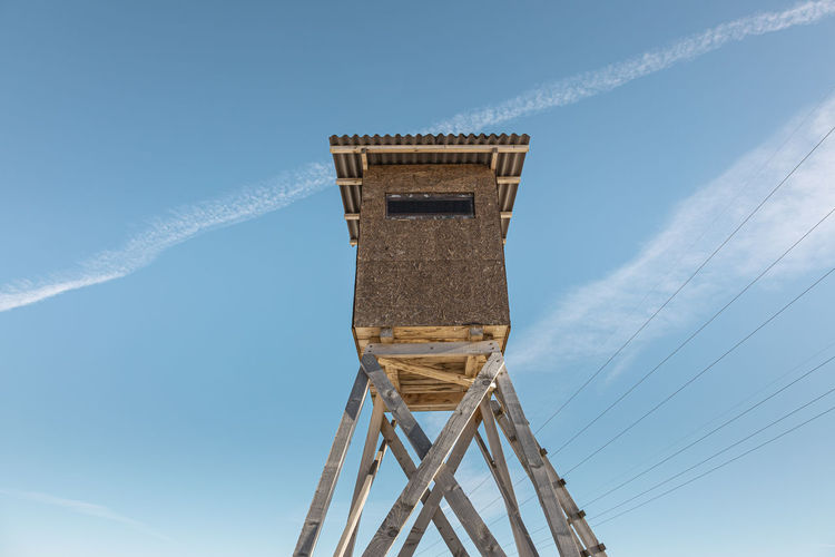 Low angle view of watchtower against blue sky