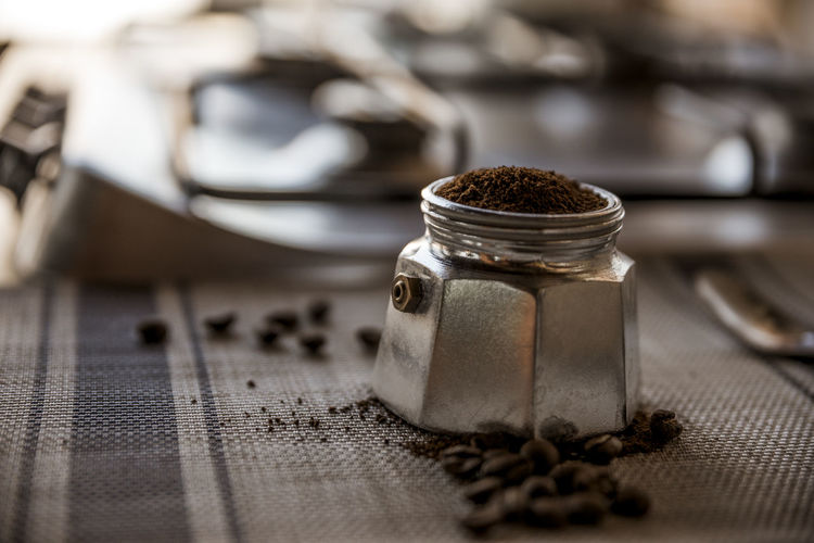 Close-up of coffee in metal container on table
