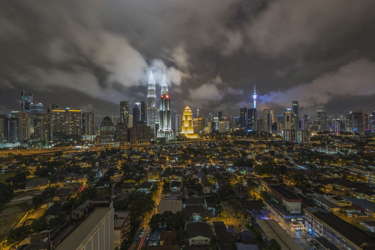 Distant view of petronas towers in illuminated city at night