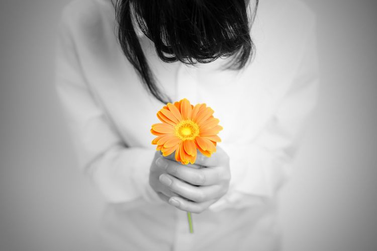 Close-up of woman holding flower