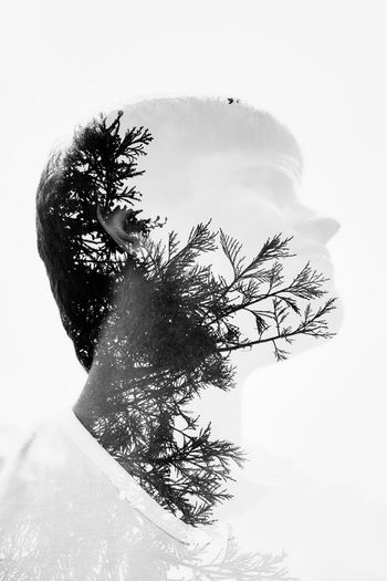 Digital composite image of man and tree against sky