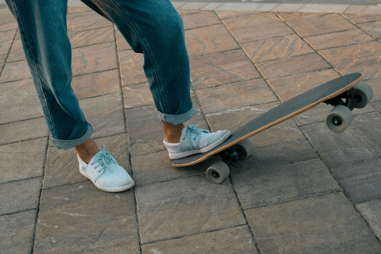 Low section of man standing on skateboard