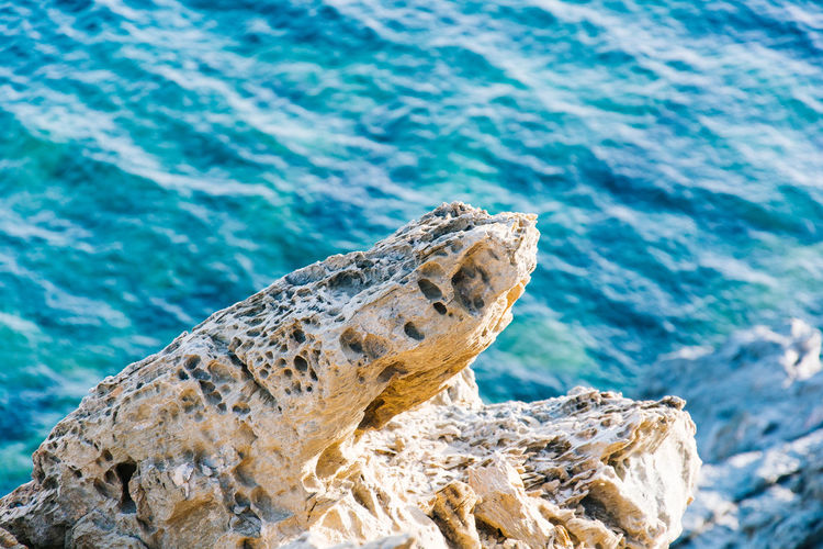 Close-up of rocks against blue sky