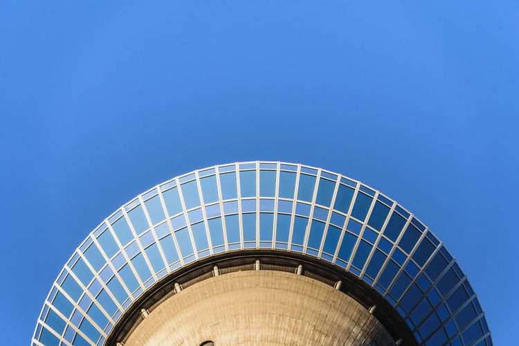 Low angle view of spiral staircase against clear blue sky