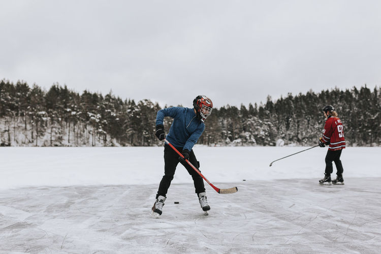 People ice-skating on frozen lake