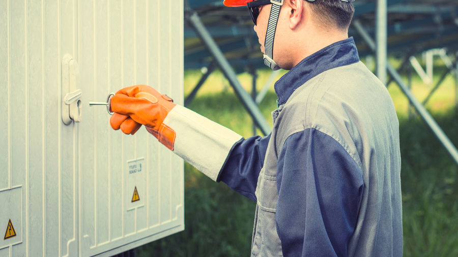 Manual worker opening door with key