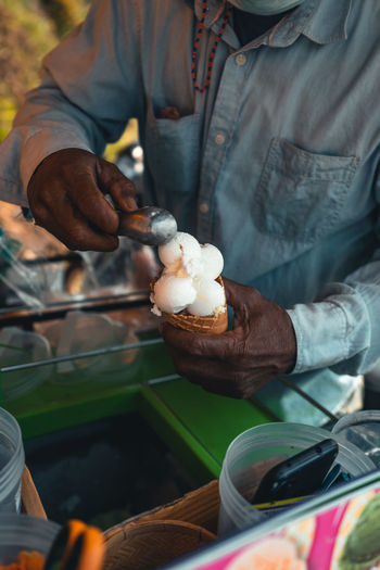 Midsection of man holding ice cream