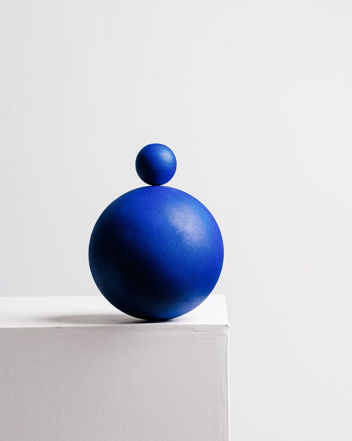 Close-up of blue spheres on table against white wall