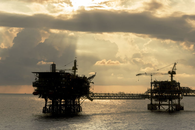 Seascape of an oil production platform during sunset golden hour at offshore terengganu oil field