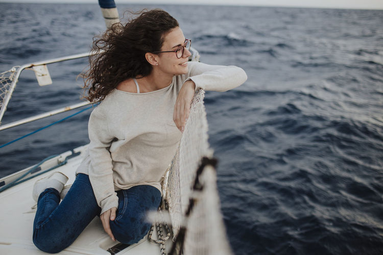 Woman enjoying vacation on sailboat
