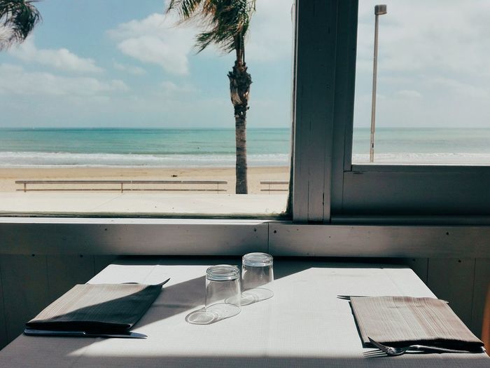 Table by window against beach