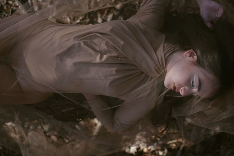 Close-up of woman lying on ground 