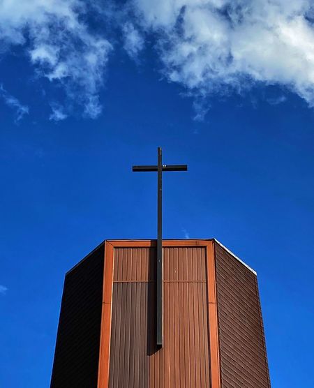 Low angle view of church building against blue sky