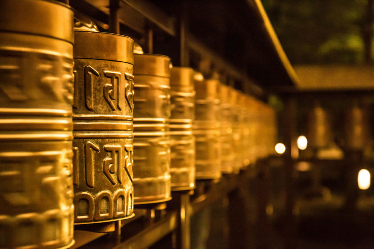 Close-up of prayer wheels in temple