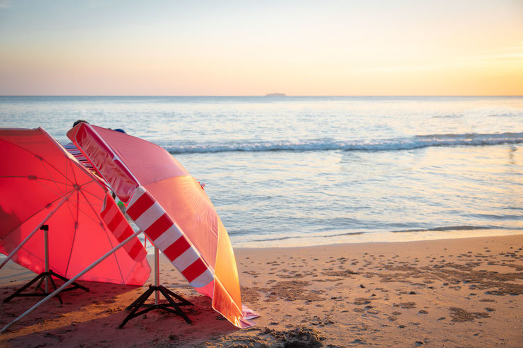 Scenic view of beach against sky during sunset