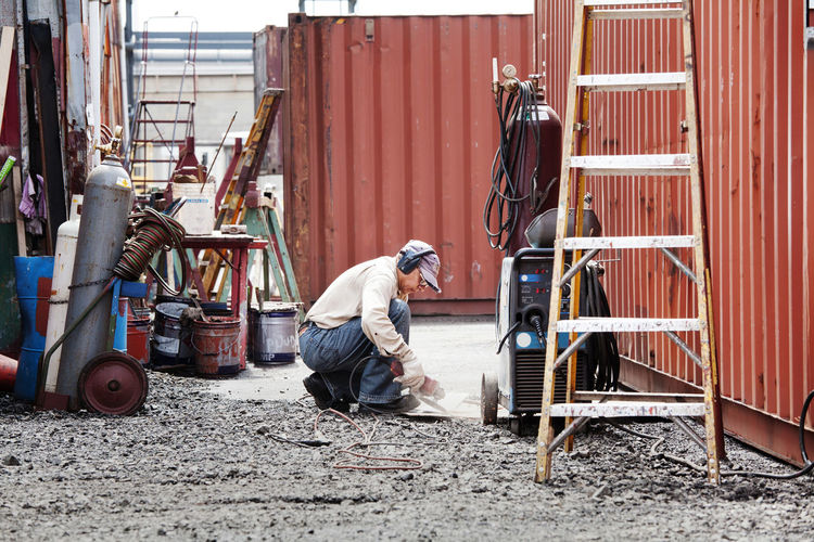 Side view of man working at commercial dock