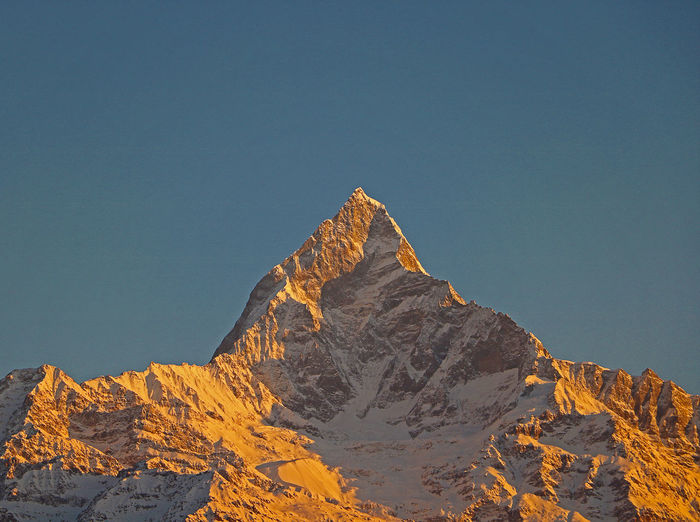 Low angle view of machapuchare mountain against sky 