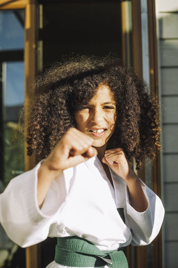 Portrait of girl doing martial arts at home