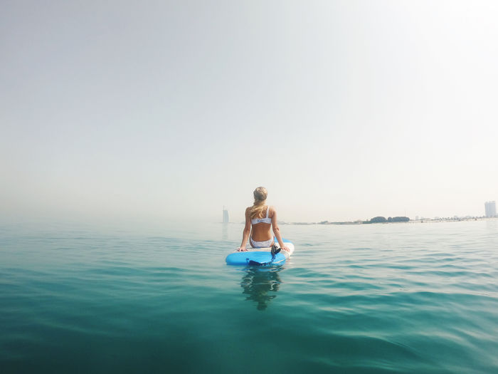 Woman sitting on the paddle board with a view on burj al arab