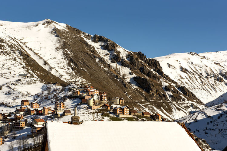 Snow covered mountains against clear sky