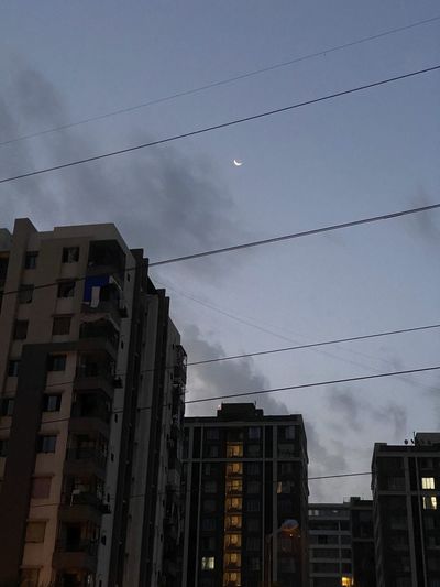 Low angle view of buildings against sky at dusk