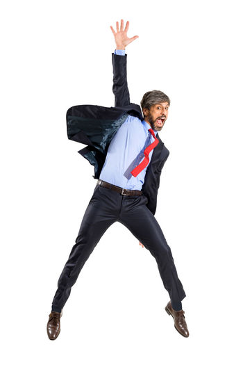 Low angle view of man jumping against white background