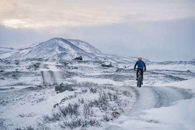Man cycling in snow