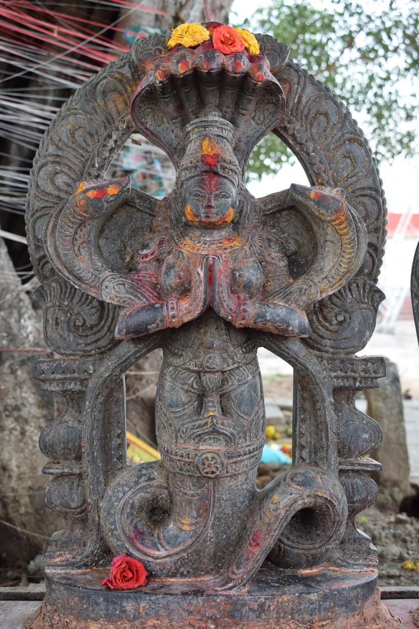 CLOSE-UP OF STATUE IN TEMPLE