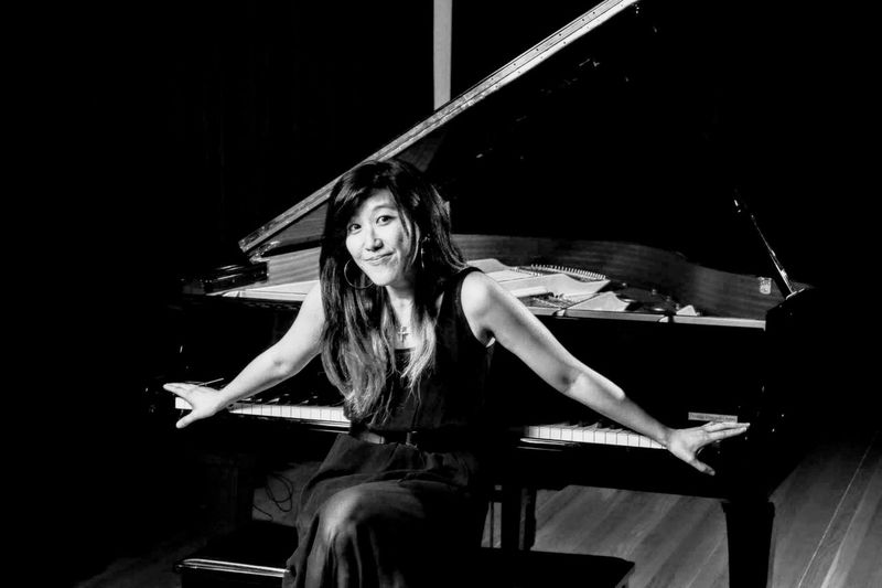 Portrait of young woman sitting on stage beautiful lady, piano, grant, pianist, black and white