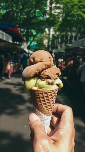 Cropped hand holding ice cream cone