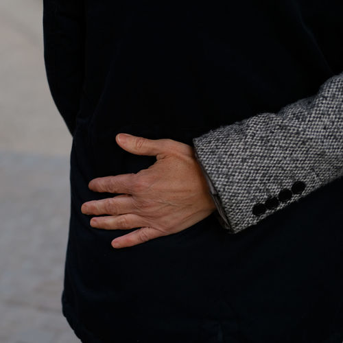 Cropped hand of man touching woman waist