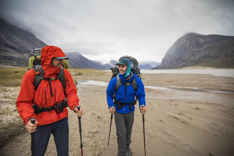 Two backpackers enjoy hiking in remote location, baffin island.
