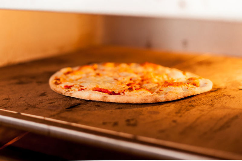 Close-up of pizza slice in oven