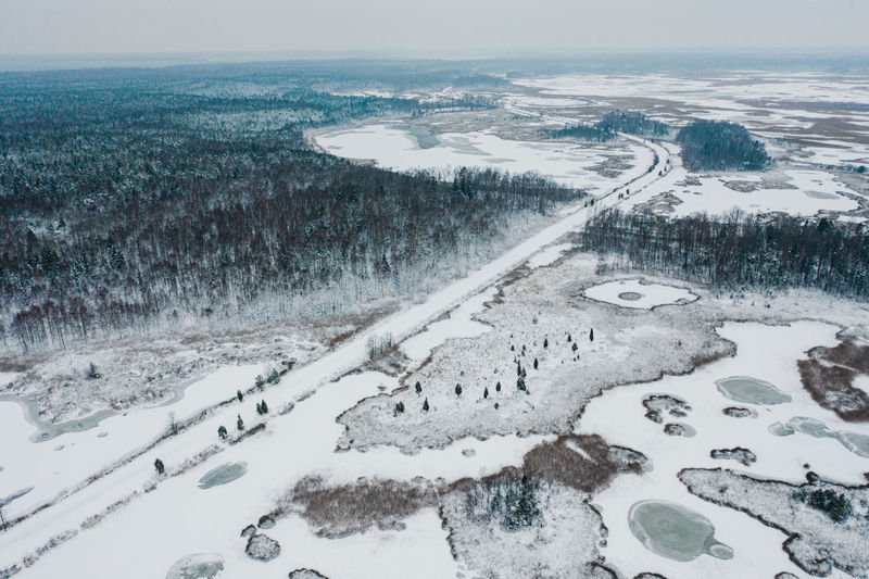 High angle view of snow covered shore against sky