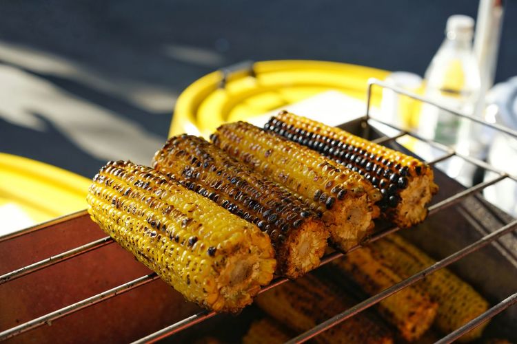 High angle view of corns on barbecue grill