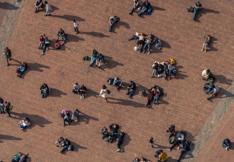 High angle view of people on street during sunny day