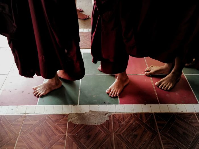 Low section of monks standing in temple