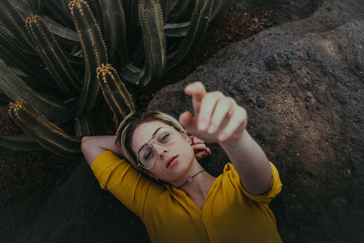 High angle view of young woman lying on rock