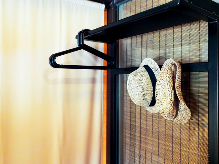 Close-up of clothes hanging on table against wall at home