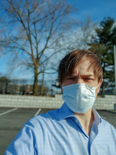Employee wearing a face mask goes back to work during the covid-19 pandemic.