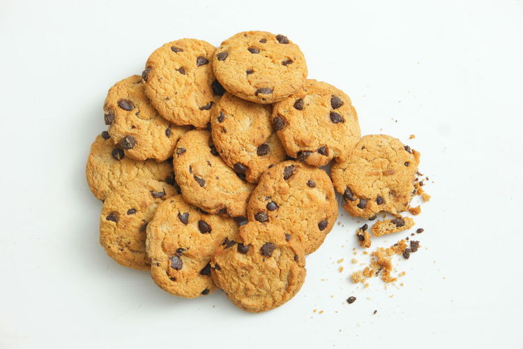 High angle view of cookies in plate against white background